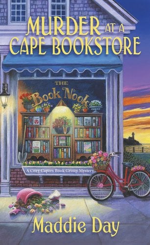 A sunset lit bookshop with "The Book Nook" in gold text. A red bicycle covered in flowers rests to the right of the shop with an overturned flower basket sits to the left of the shop.