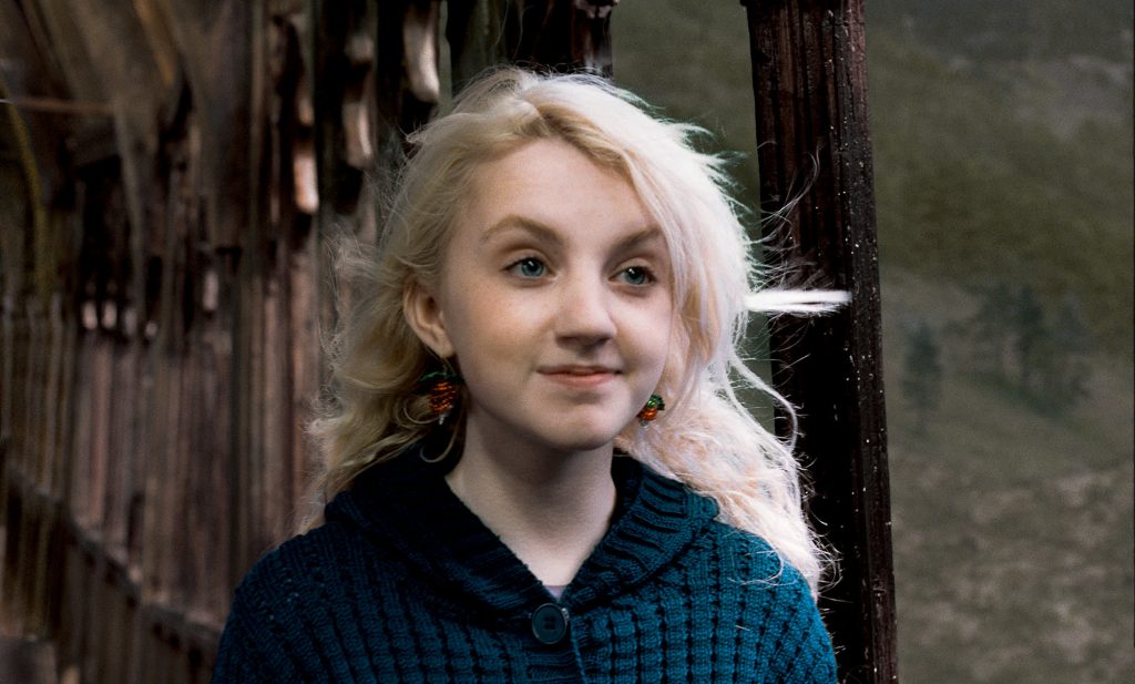 luna lovegood on the hogwarts bridge wearing a blue sweater