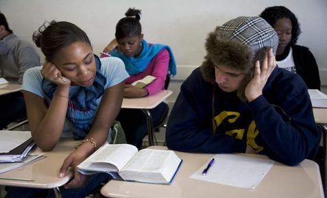 Two students sharing a textbook.