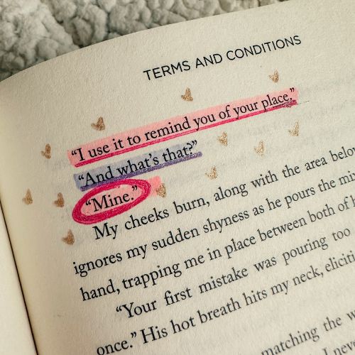 Annotated book romance page. Three lines are highlighted, first in pink, then purple, then pink again. The lines are underlined in matching glitter pen. Gold glitter hearts are drawn around the highlights.