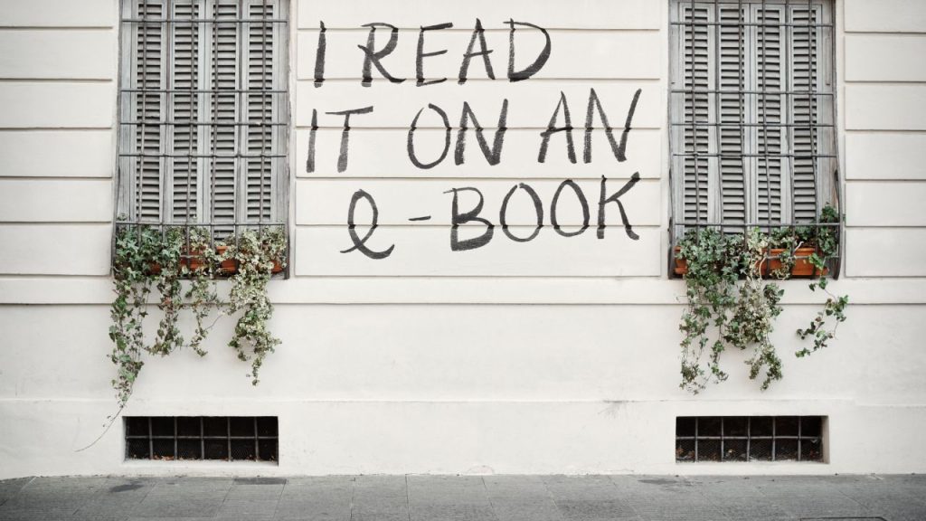 "I read it on an e-book" painted between two windows on the side of a house.