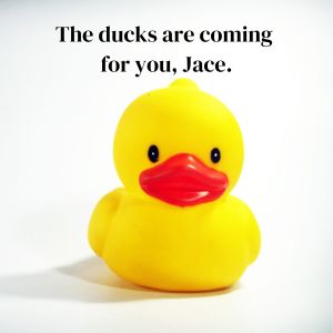A yellow rubber duck with text above its head.