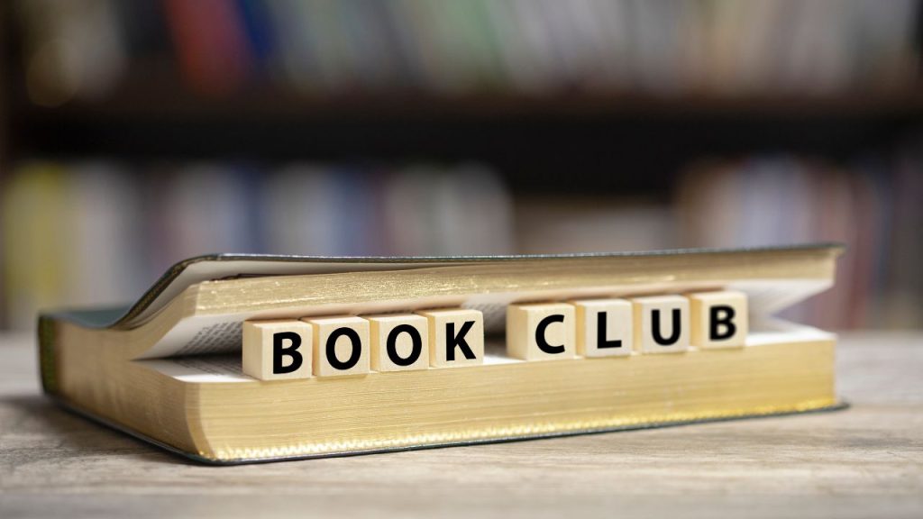 Opened book with blocks that read: Book Club