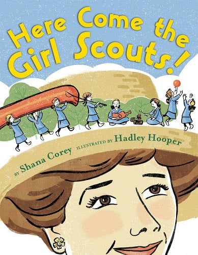 A woman wearing a hat looks up at the brim to see several girls doing various activities.