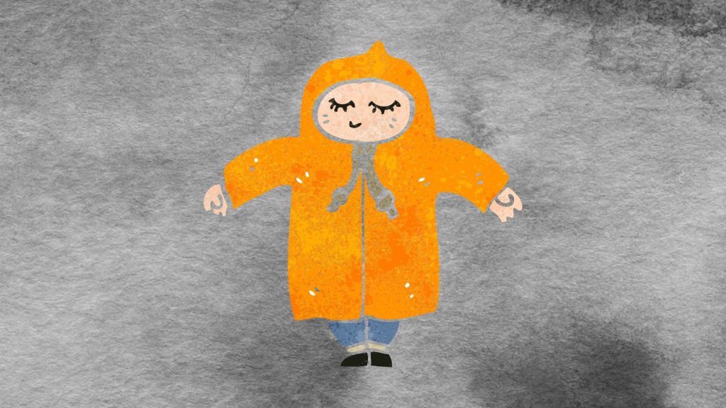 Person in a big coat on a dark gray background.