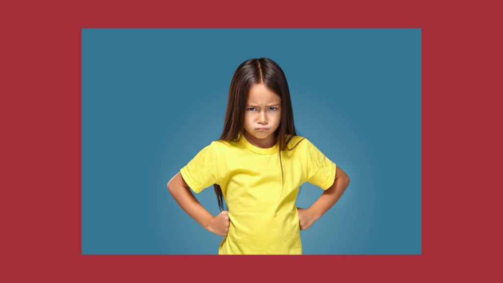 Angry girl on red background.
