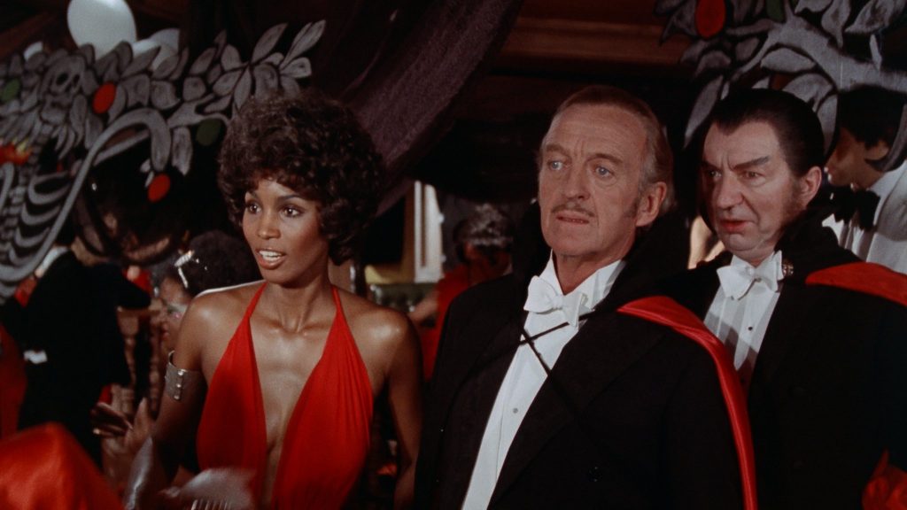 vampira, dracula, and another vampire with red and black clothes.