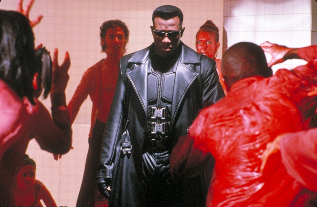 wesley snipes as blade in a black leather suit and jacket surrounded by people covered in blood