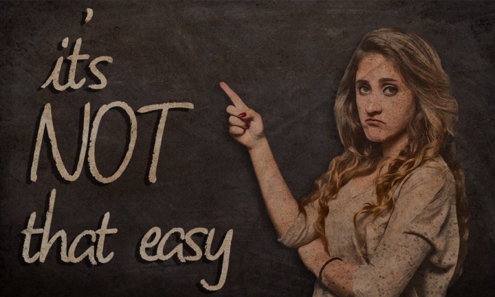 Woman standing next to chalkboard with the message 'it's not that easy.'