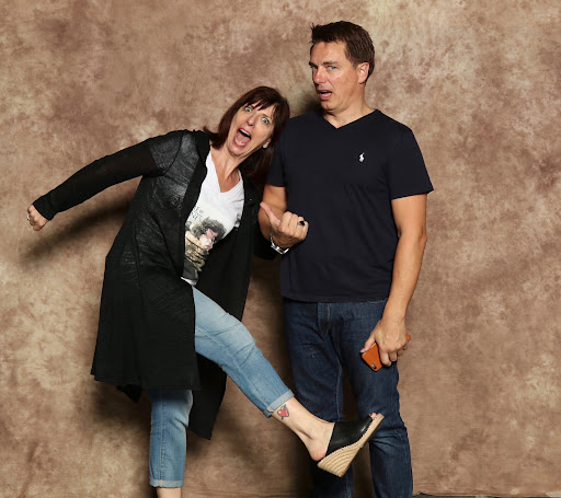 Carole and John Barrowman being silly and making faces at the camera.