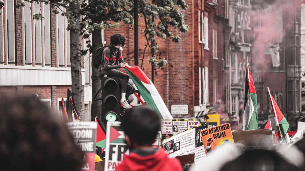 A protest in support of Palestine happening on a city street.