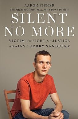 A neutral earth tone for the background. This is a portrait of the author in a red shirt and jeans, sitting on a wooden chair. Across the top of the cover in black text, it reads: Aaron Fisher and Michael Gillum, M.A., with Dawn Daniels. Below that in bold large white text, it reads in all caps: Silent No More. And below that in black text again, it reads: Victim 1's fight for justice against Jerry Sandusky.