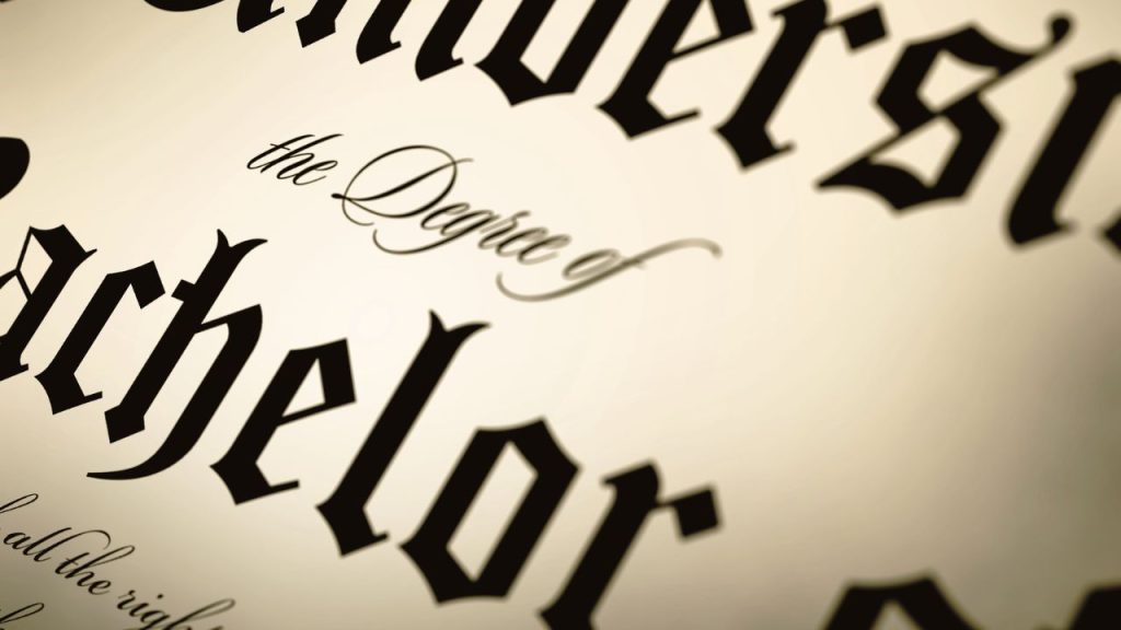 A zoomed-up image of a diploma so that the words "university" and "the Degree of Bachelor" are legible.