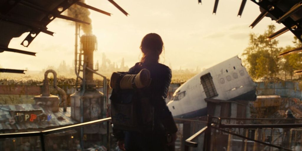 A woman with a backpack looking out into a decrepit world.
