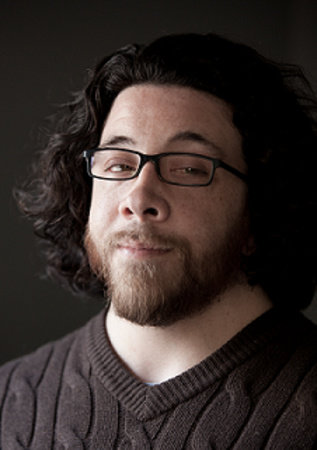 Saladin Ahmed looking to the side with a raised eyebrow.
