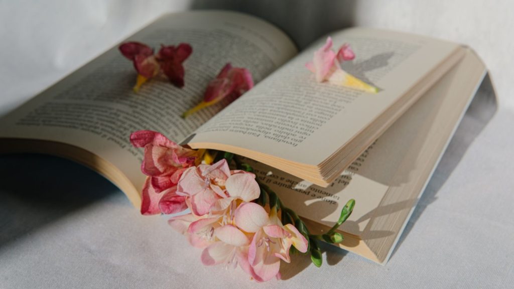 Books with flowers between pages.