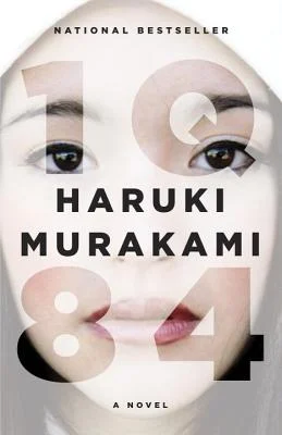 '1Q84' by Haruki Murakami book cover showing a woman's face behind the title.