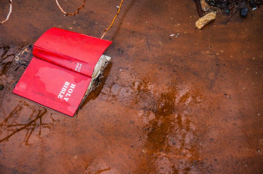 Book discarded on the ground.