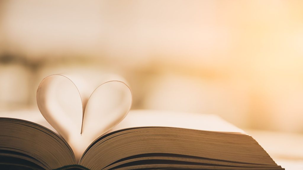 A book with two pages folded together, making a paper heart.