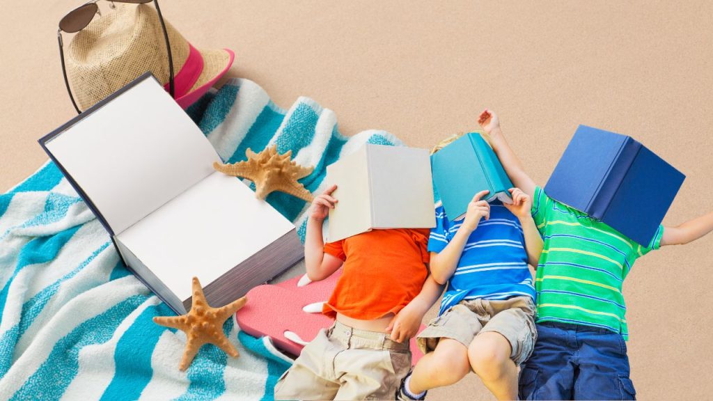 Kids reading books while laying on the beach.