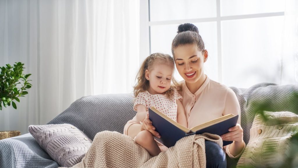 mother and daughter reading a book