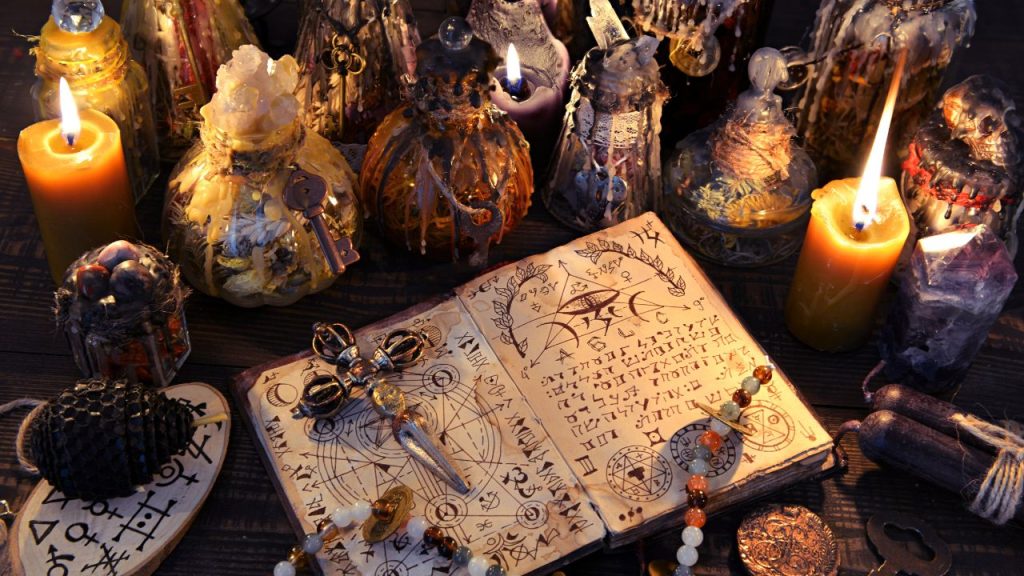 witches book with potions all around it