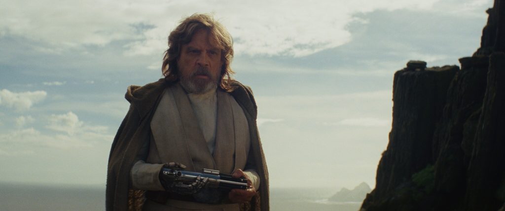 Luke Skywalker looking at Rey with confusion.