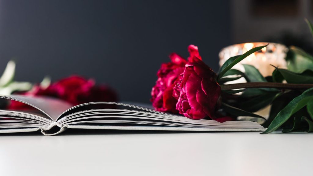 Opened book with flowers laying on top