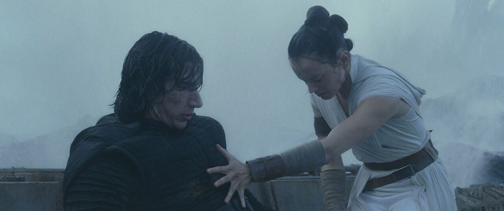 Rey uses the force to heal Kylo Ren after stabbing him in the chest.