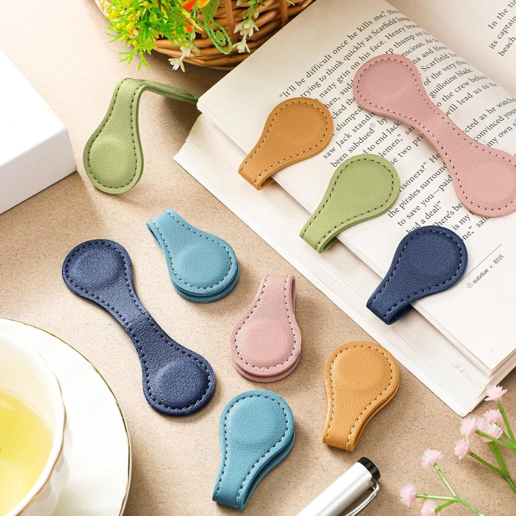 Leather magnetic book marks on a book and laying open on a table.