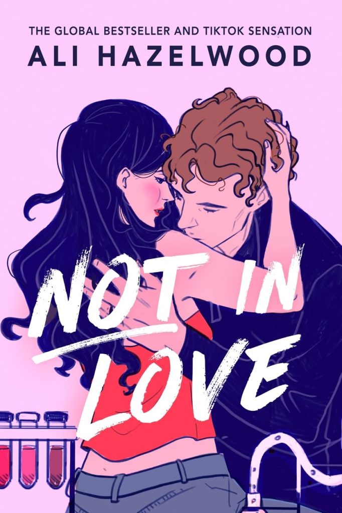A girl and guy embracing, kissing, in a lab.