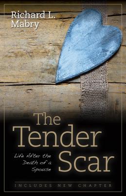 'The Tender Scar: Life After the Death of a Spouse' by Richard Mabry boo cover with a small blue heart on a wooden table.