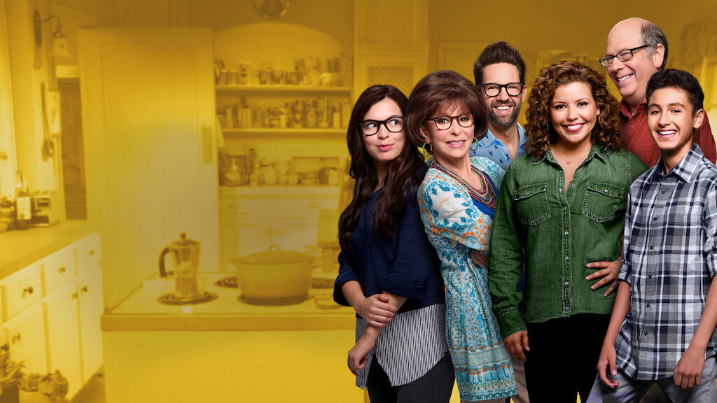 Yellow background overlaying a kitchen with six characters standing on the side. Each character is smiling at the camera like a happy family.