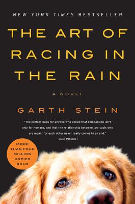 A dog poking his head at the bottom of the book, Enzo.
