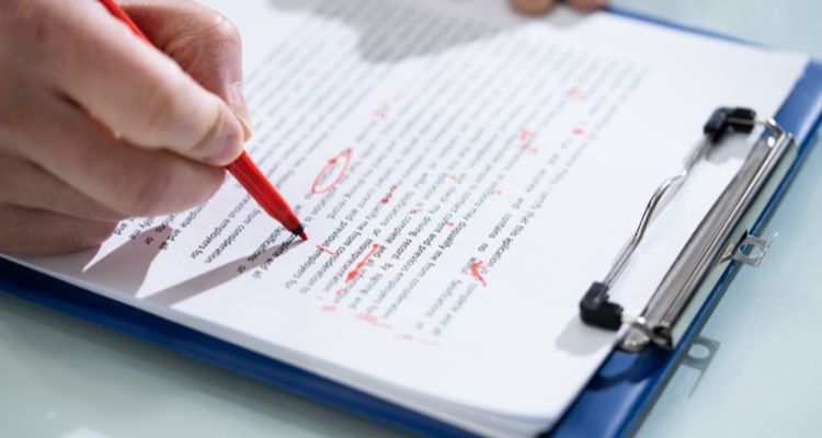 editing a writing assignment on a clipboard