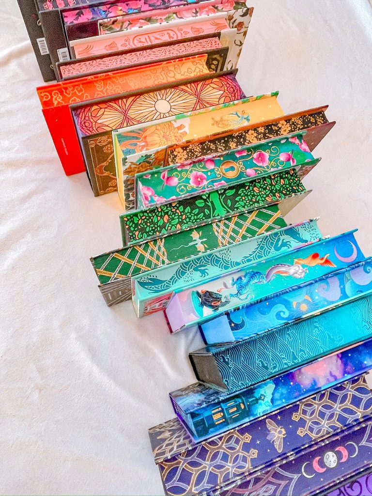 Line of stacked colorful books Frank owns.
