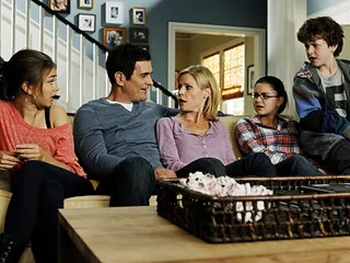 Phil Dunphy from Modern Family. The Dunphy family sitting on the couch and talking.