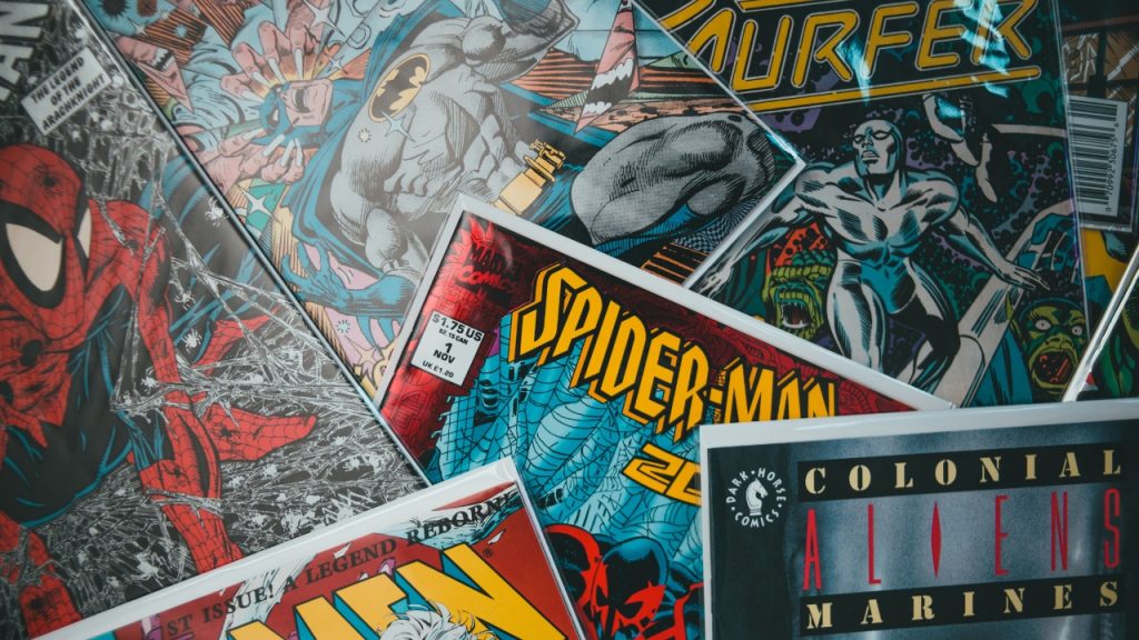 Stack of superhero comics, including Spider-Man and Batman.