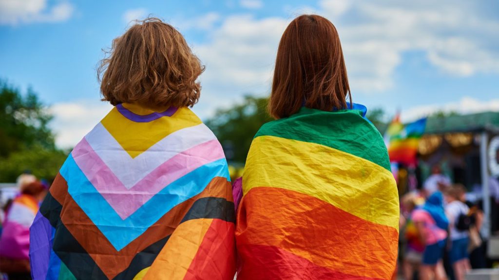 two persons envolved in pride flags