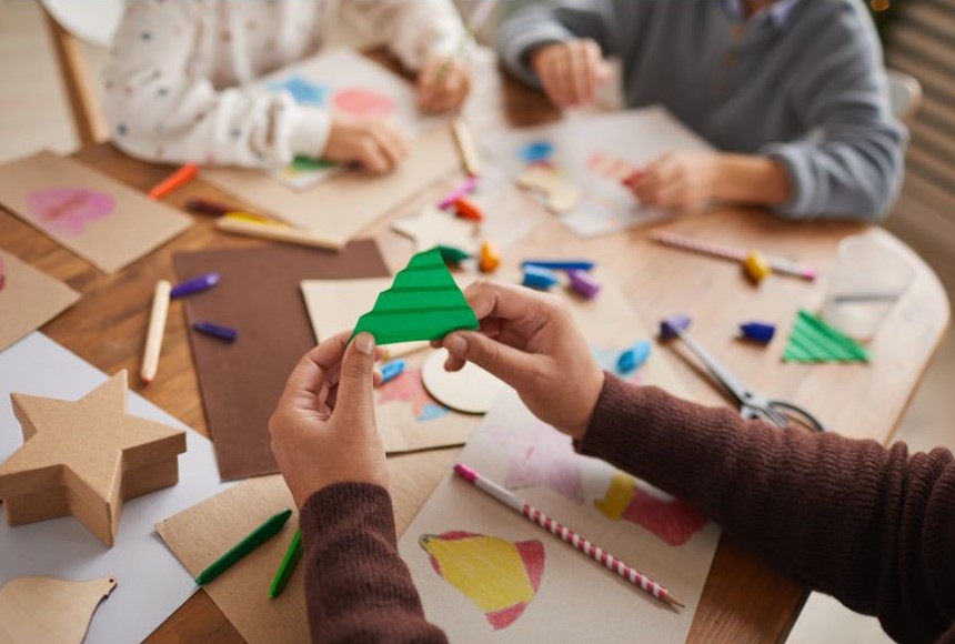People crafting and drawing at a small table.