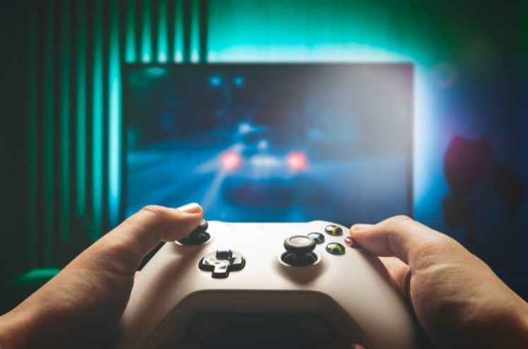 A person holding a controller and playing a game.