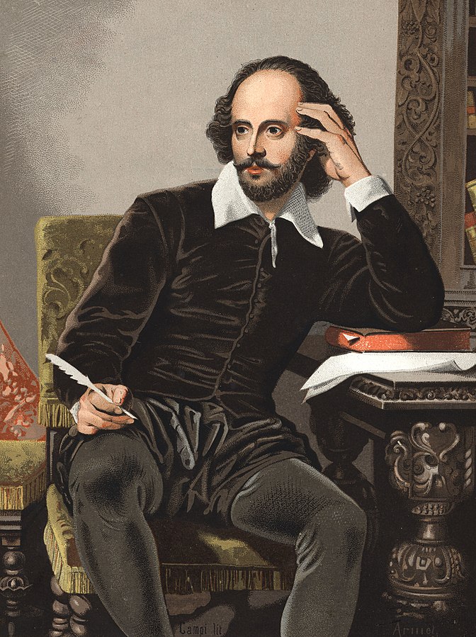 Playwright and poet William Shakespeare sitting in a chair with a quill in one hand and the other propped up on top of a closed book sitting on a table.