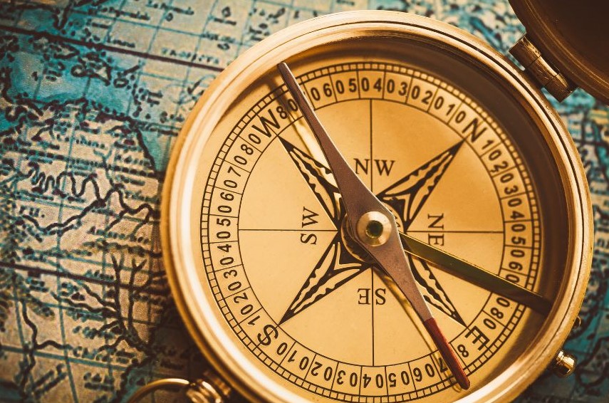 A compass resting on a map