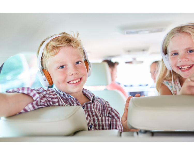 Children listening to a audiobook in the car.