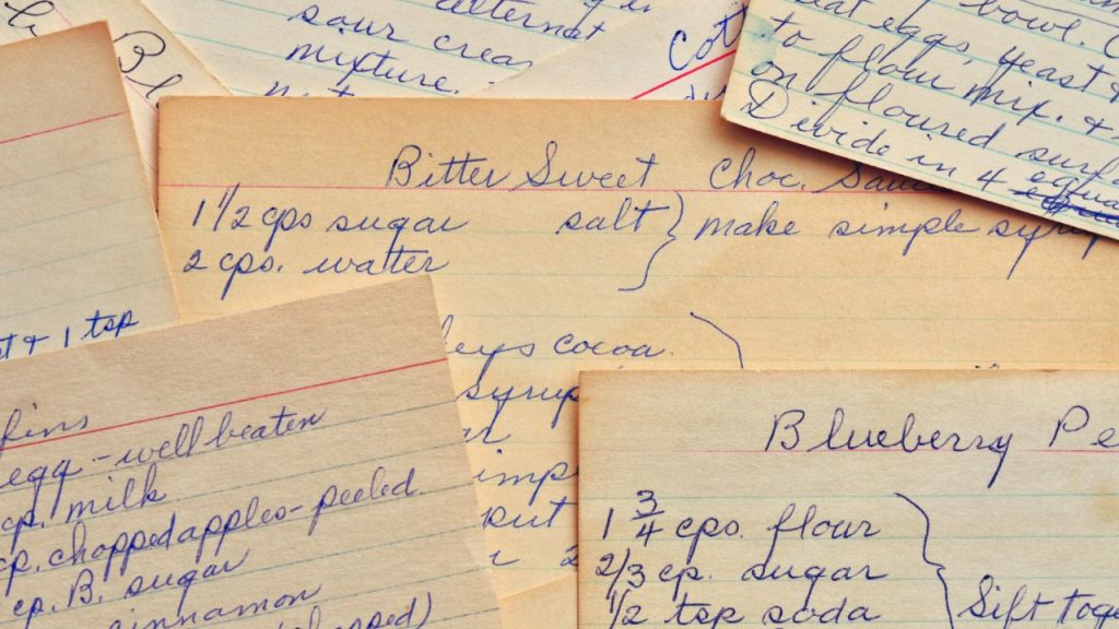 A variety of recipe cards written in blue pen in cursive.