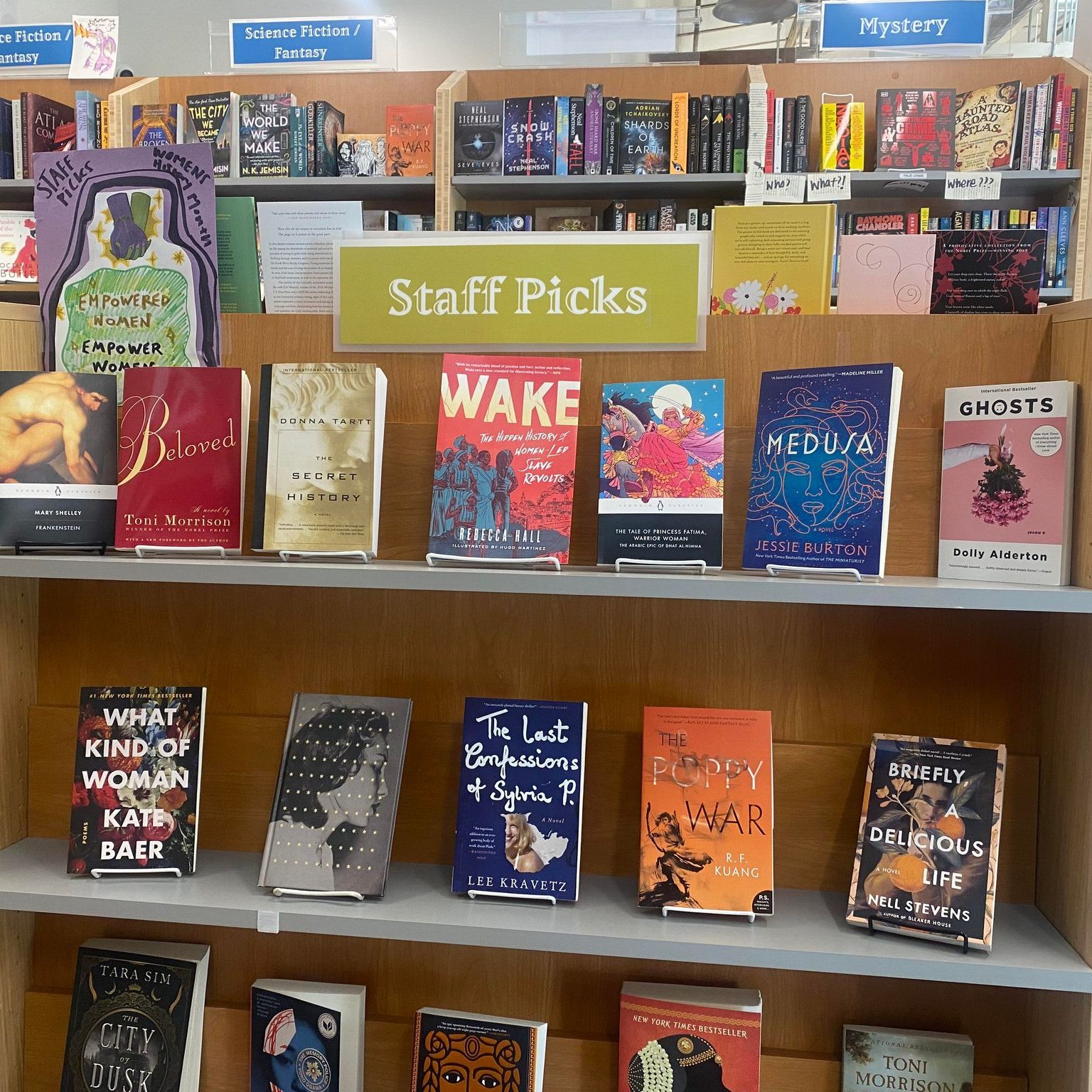 "Staff picks" shelf at Books Inc. displaying various books.