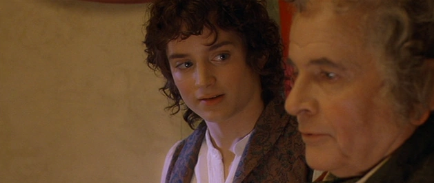 Frodo looking at Bilbo.