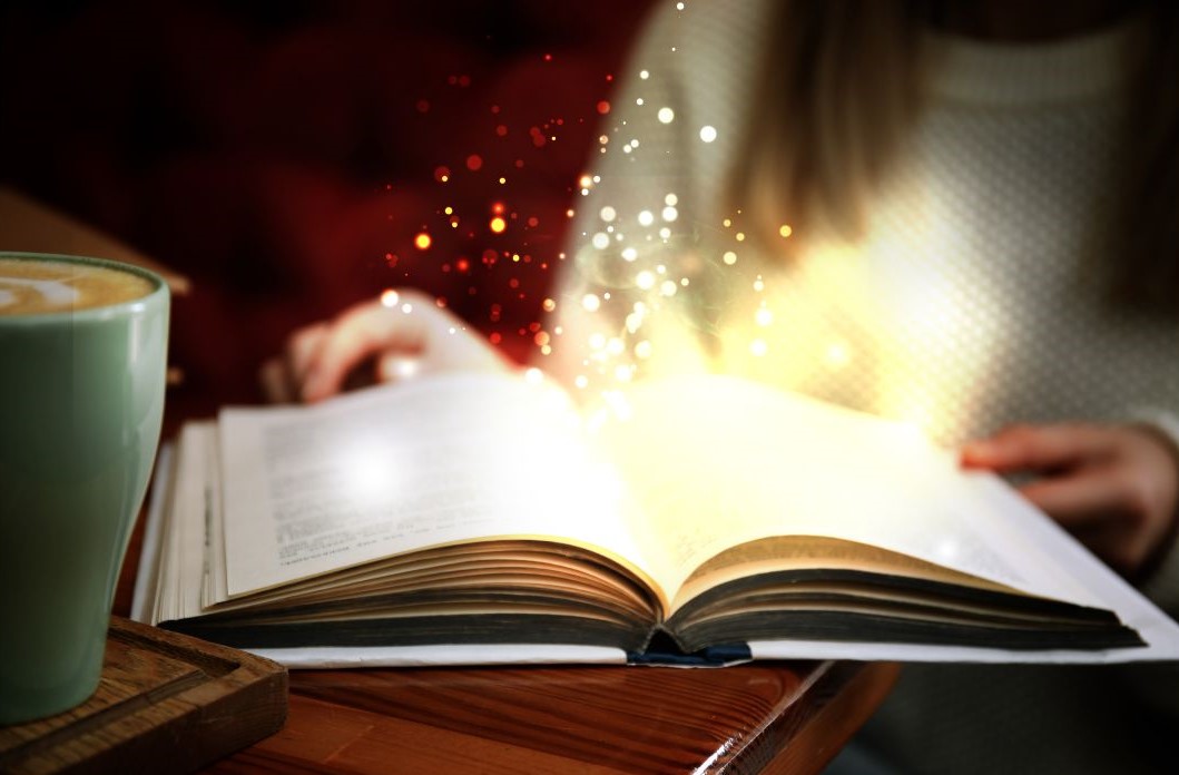 Magic and sparkles coming out of an open book.