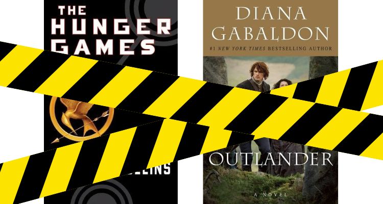 The Hunger Games by Suzanne Collins and Outlander by Diana Gabaldon book covers covered with black and yellow tape.