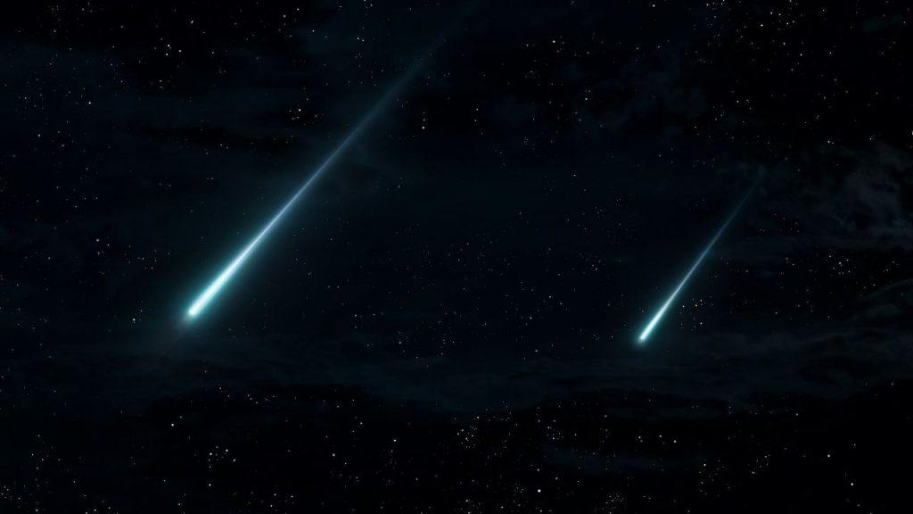 A black sky with stars and two comets.